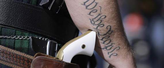 Scott Smith, a supporter of open carry gun laws, wears a pistol as he prepares for a rally at the Capitol, Monday, Jan. 26, 2015, in Austin, Texas. (AP Photo/Eric Gay)
